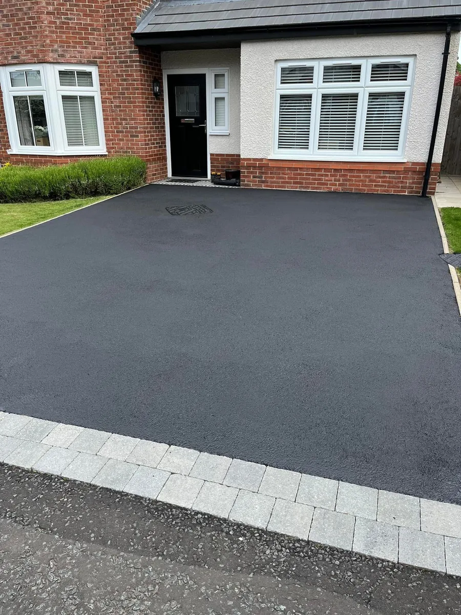 Driveway after cleaning — deep black, restored tarmac