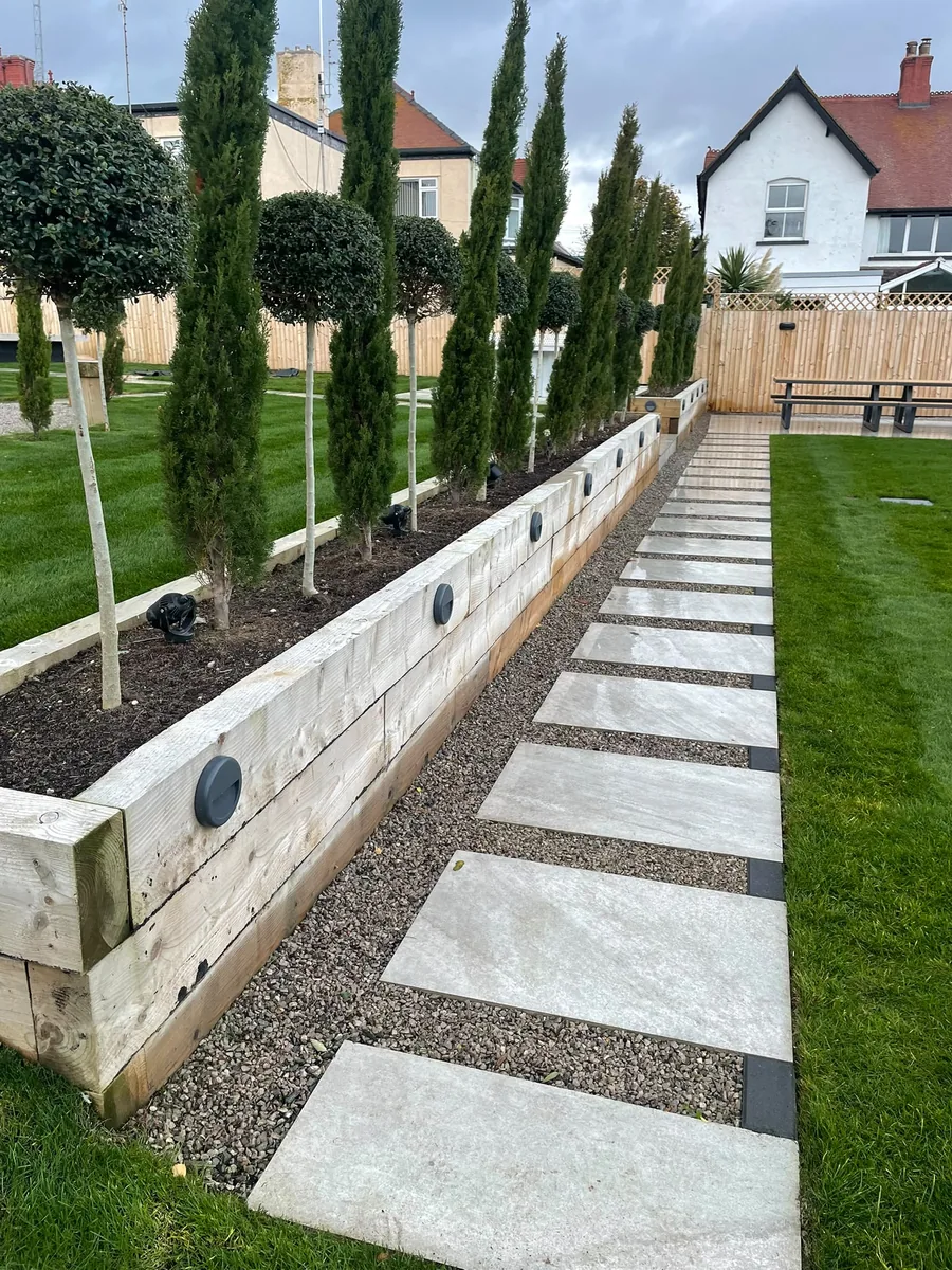 Garden landscaping with sleeper bed and stone pathway