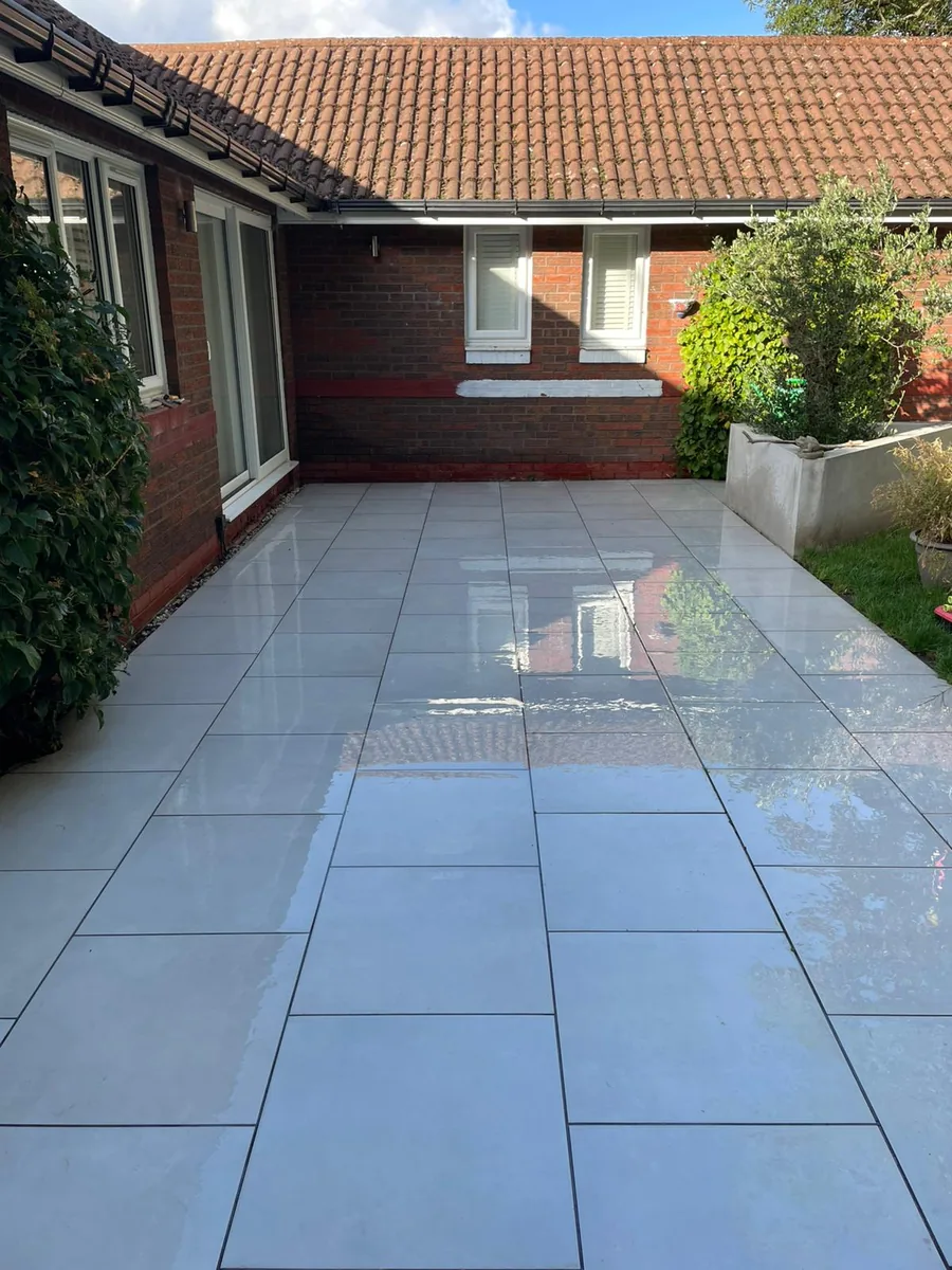 Patio after pressure washing — clean, gleaming slabs